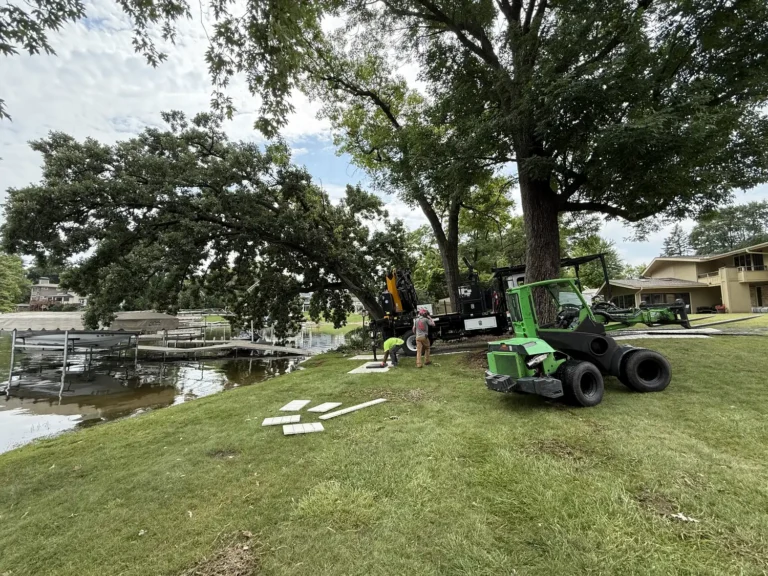 Uprooted tree threatening pier boat and jet ski after flooding at Muskego Lake, Wisconsin