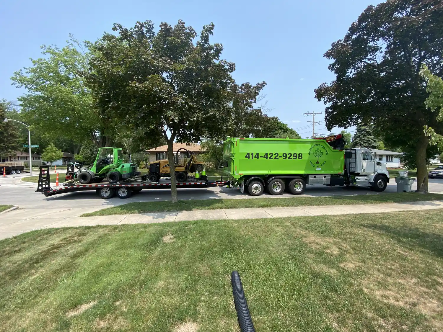 Russ Tree Service crew performing professional tree removal near a home in New Berlin Wisconsin